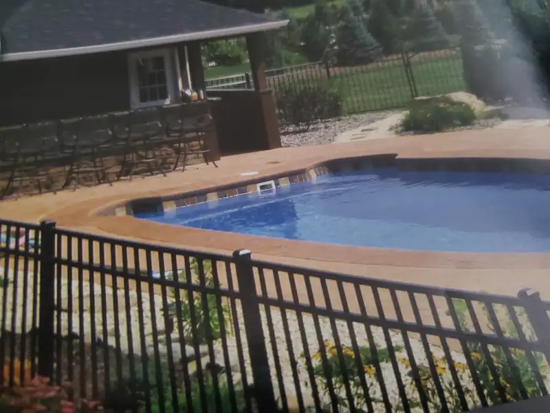 Black aluminum pool safety fence around in-ground pool by Fencing By Excellence near Aberdeen, Monmouth County NJ