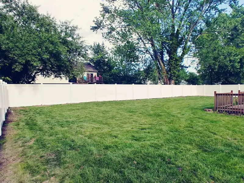 White vinyl privacy fence landscape view by Fencing By Excellence near Rumson, Monmouth County NJ