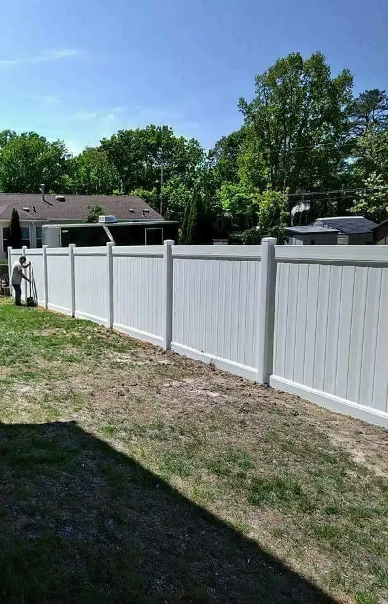 White vinyl fence in landscape setting by Fencing By Excellence near Aberdeen, Monmouth County NJ