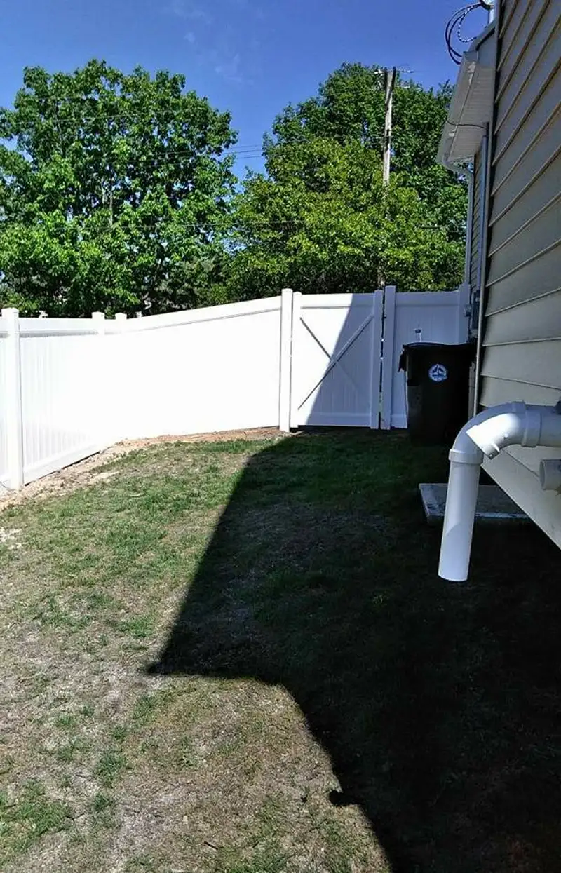 Vinyl fence with pool area visible by Fencing By Excellence near Matawan, Monmouth County NJ