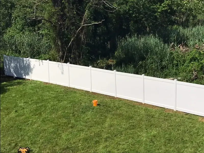 White vinyl fence long property line view by Fencing By Excellence near Matawan, Monmouth County NJ