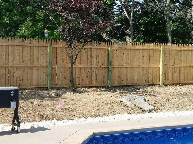 Wood stockade privacy fence around pool area by Fencing By Excellence near Rumson, Monmouth County NJ