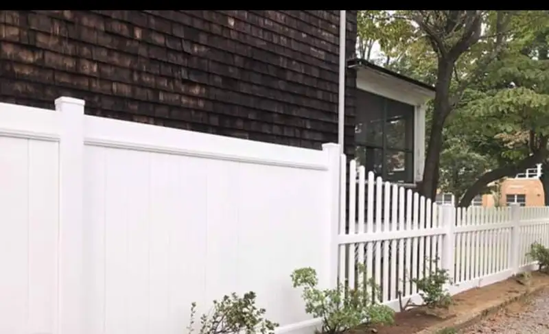 White vinyl fence with solid bottom and spindle top by Fencing By Excellence near Aberdeen, Monmouth County NJ