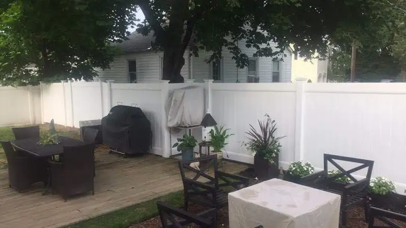 White vinyl fence with ornamental gate hardware by Fencing By Excellence near Aberdeen, Monmouth County NJ